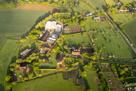 Aerial view of a farm and surrounding fields in the countryside in Kent, UKの写真素材