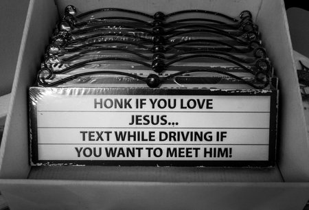 Humorous sign reading: honk if you love Jesus... Text while driving if you want to meet himの写真素材