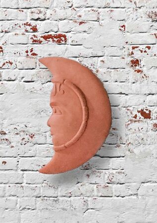 Clay moon hanging on the wallの写真素材