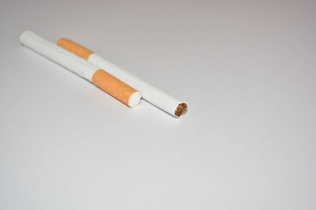Photos smoking two cigarettes a white background.