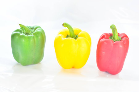 Fresh vegetables Three sweet Red, Yellow, Green Peppers isolated on white backgroundの写真素材