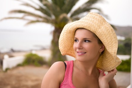 Portrait of young sexy romantic summer woman in large hat relaxing in the resort outdoors. copy spaceの写真素材