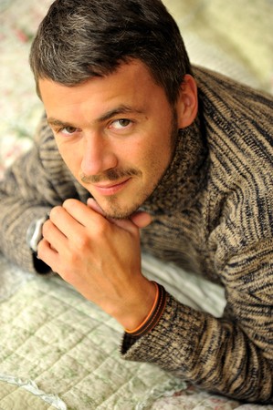 picture of young handsome seductive men on a bedの写真素材