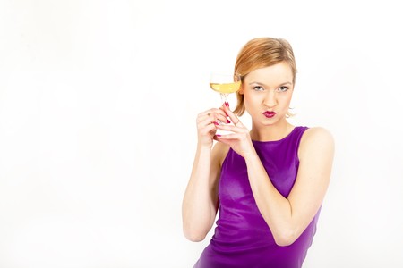 young beautiful woman drinking champagne celebrating an event.isolated on whiteの写真素材