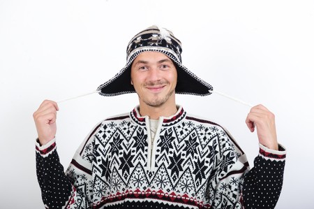 Handsome winter man in warm clothes and hat making funの写真素材