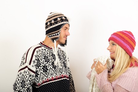 Handsome winter couple in warm clothes huging and kissingの写真素材