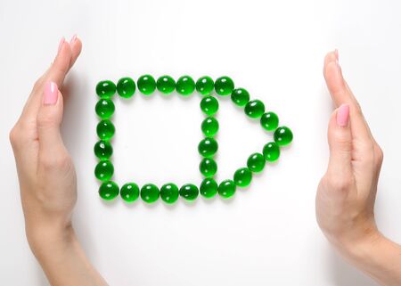 beautiful womans handsholding house icon made of little stonesの写真素材