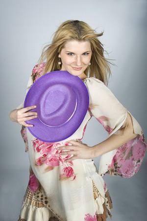 Beautiful model woman in flower dress and a hatの写真素材