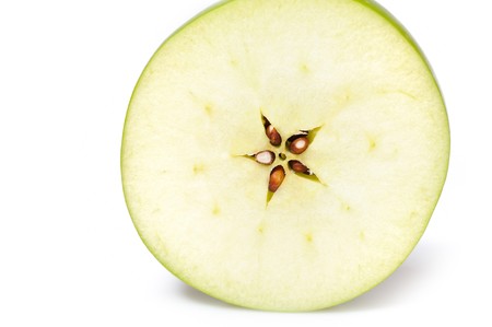 fresh green apple cut into slices. isolated on white backgroundの写真素材