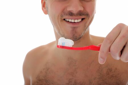 Middle aged man brushing his teeth in the morning. isolated on white background の写真素材