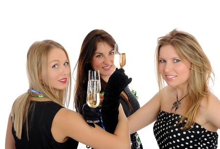three beautiful woman with glasses of champagne celebrating on party. isolated on white backgroundの写真素材