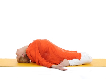 series or yoga photos. young woman in fish pose on yellow pilates mat