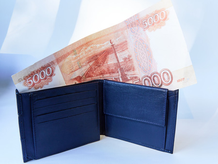 Background white, black men's wallet with bills of various currencies, isolated
