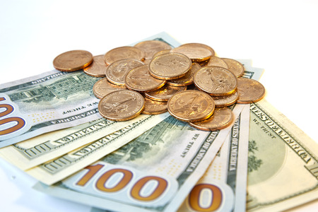 Design element. Heap of yellow shine us dollars on a fan of hundred dollar bills. top view...