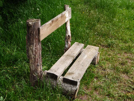 Wooden bench in green grass in the meadowのeditorial素材