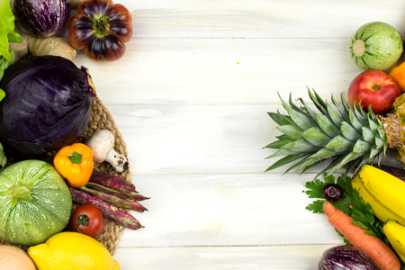 FRAME OF VEGETABLES AND FRUITS ON WHITE WOODEN BACKGROUND. COPY SPACE, HORIZONTAL HIGH ANGLE VIEWの写真素材