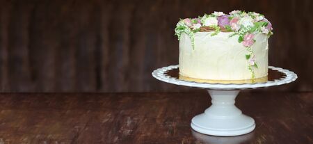 Beautiful white cake on spinning boardの写真素材