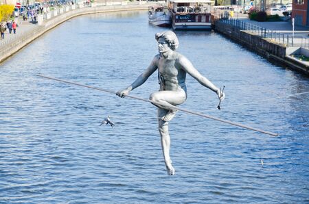 BYDGOSZCZ, POLAND. 8th APRIL 2017. The tightrope-walker sculpture over the River Brda is one of the many cultural attractions that are pulling tourists into the cit of Bydgoszcz in ever greater numbers.のeditorial素材