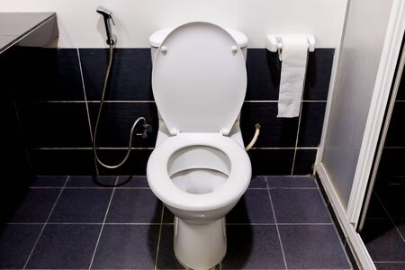 White toilet in the black bathroomの写真素材