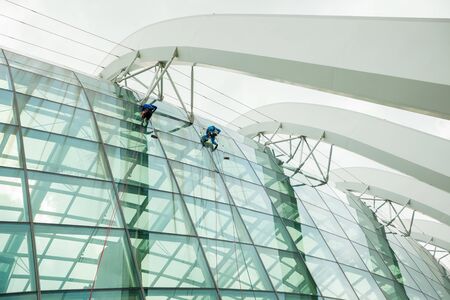 workers wash Windows at heightの写真素材