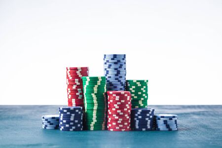 Stack of poker chips on the table on a white background isolateの写真素材