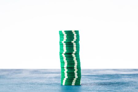 Stack of green poker chips on white background isolateの写真素材
