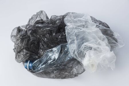 Plastic bags and crumpled bottles on a light backgroundの写真素材