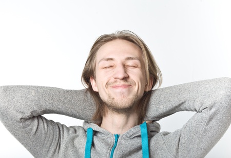 Portrait of young man with long blond hair on a white backgroundの写真素材