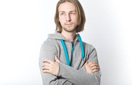 Portrait of young man with long blond hair on a white background