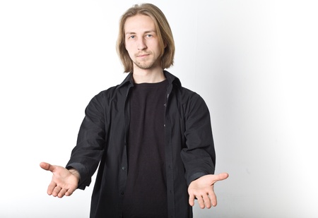 Portrait of young man with long blond hair on a white background