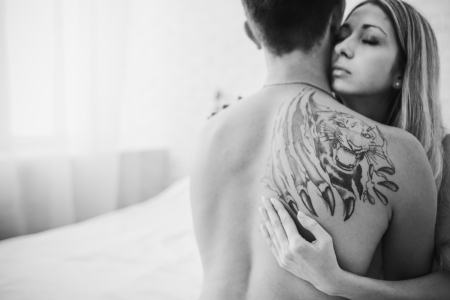 Young attractive happy amorous couple in bedroomの写真素材