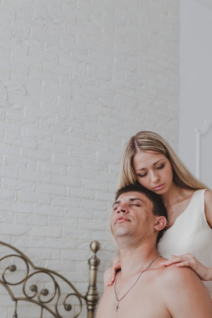 Young attractive happy amorous couple in bedroomの写真素材