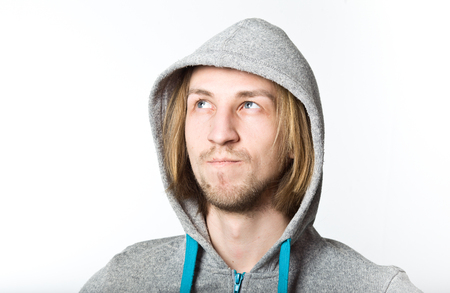 Portrait of young man with long blond hair on a white backgroundの写真素材
