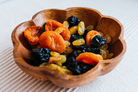 healthy food - vegan snacks with dry apricots, plums, and raisins, selective focusの写真素材