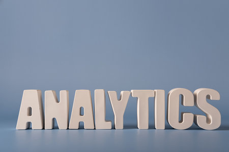 Word Analytics made from white concrete letters on the blue background.の写真素材