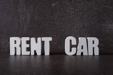 Word Rent car made from white concrete letters on the blue background.の写真素材