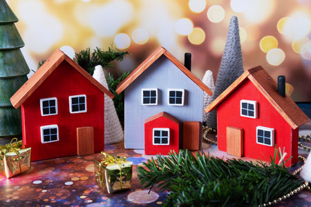 Three wooden toy houses. Christmas village in minature. A gift for the New Year.の写真素材
