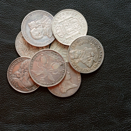 Ancient silver coins on a leather surfaceの写真素材