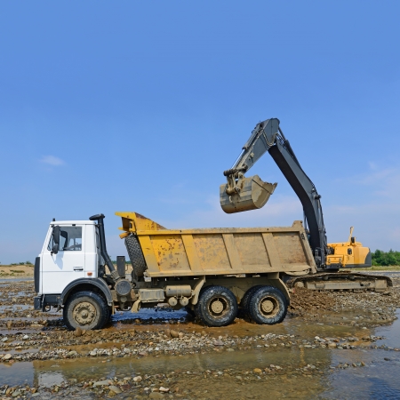 Extracting and loading gravel excavated in the mainstream of the riverの写真素材