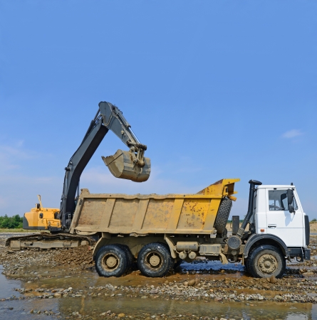 Extracting and loading gravel excavated in the mainstream of the riverの写真素材