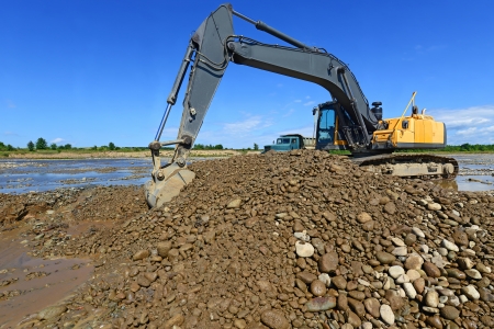 Extracting and loading gravel excavated in the mainstream of the riverの写真素材