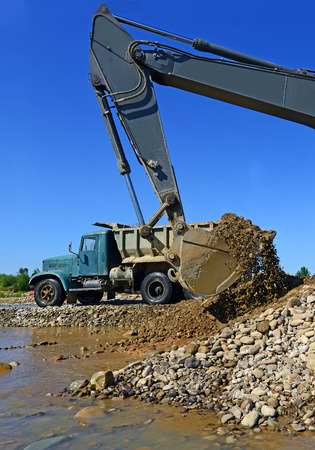 Extracting and loading gravel excavatedの写真素材