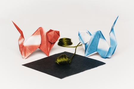 Two Colorful Origami Cats Fight Over a Ball of Yarnの写真素材