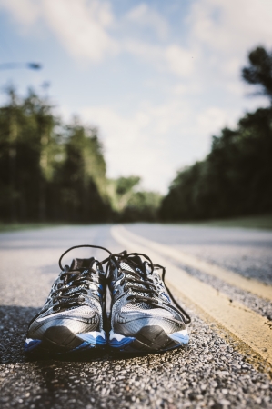 Lone pair of new running shoes, just waiting to be used on an open roadの写真素材