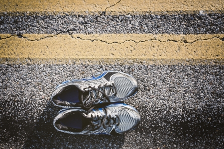 Lone pair of new running shoes, just waiting to be used on an open roadの写真素材