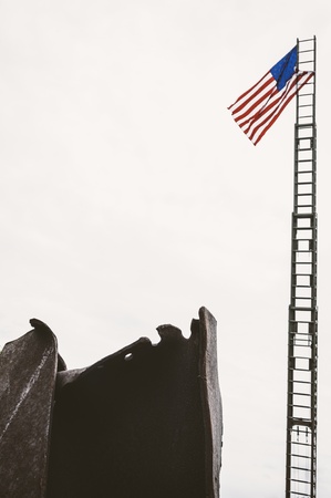 Taken in Cincinnati, Ohio, this image shows an actual section of a support beam from the World Trade Center, after the terrorist attack on 9/11.  The wreckage was on display at a vintage fire fighting equipment event, as a tribute to the firefighters of Nのeditorial素材