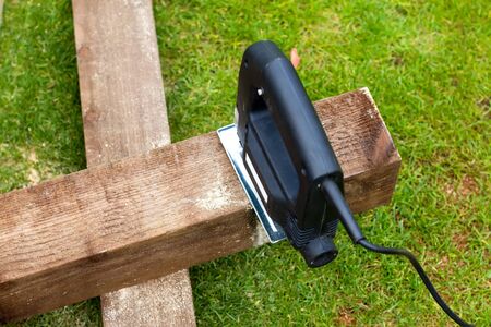 Jigsaw tool cutting a piece of wood on の写真素材