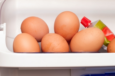 dirty eggs from chickens in fridge next to tomato pureeの写真素材