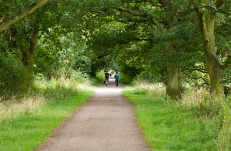 young couple walking their dog along a country pathの写真素材