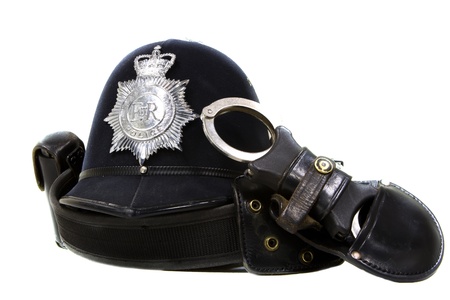 traditional british police helmet and handcuffs isolated on whiteの写真素材